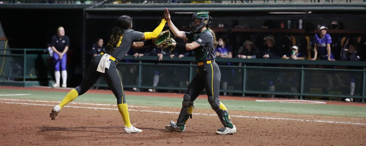 A Baylor softball pitcher and catcher high-five each other